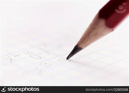 writing red pencil in closeup, selective focus on center
