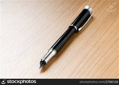 Writing silver pen on the wooden background