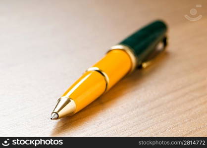 Writing silver pen on the wooden background