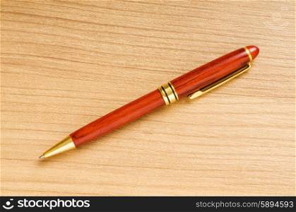 Writing silver pen on the wooden background