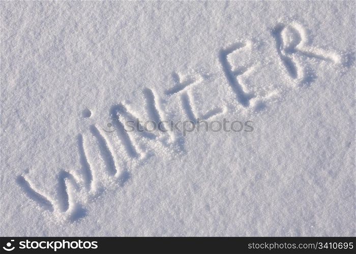 "writing text "WINTER" in sunny day on the snow"
