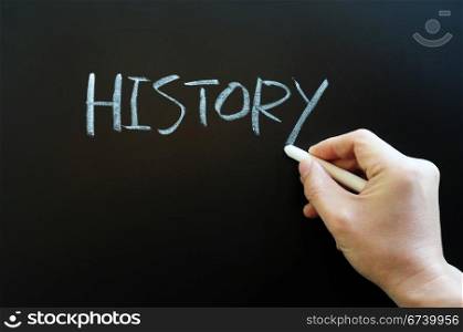 Writing the word history with chalk on a blackboard