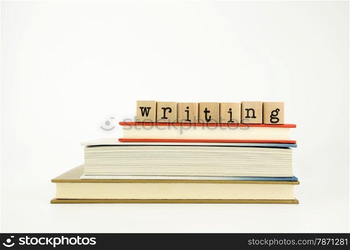 writing word on wood stamps stack on books, study and academic concept