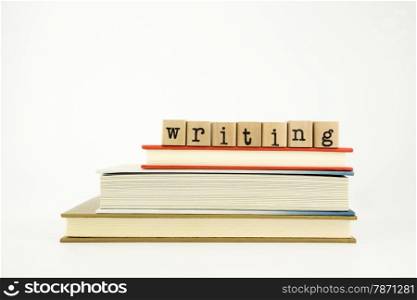 writing word on wood stamps stack on books, study and academic concept