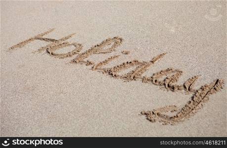 Written on the sand of the beach: Holiday