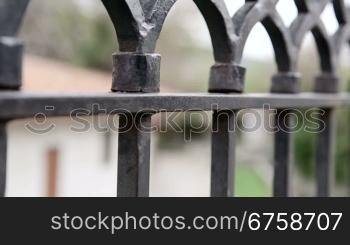 Wrought iron fencing close-up dolly shot