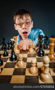 Wunderkind play chess. Funny Nerd boy.