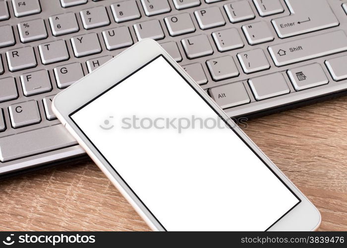 &#x9;Smartphone laying on keyboard with copy space on screen