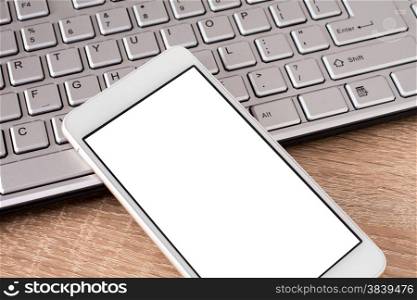 &#x9;Smartphone laying on keyboard with copy space on screen