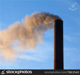&#xA;A large black smokestack sends smoke up into a clear blue sky.&#xA;