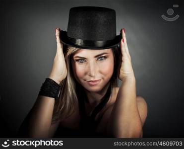 &#xA;Closeup portrait of beautiful blond female with perfect makeup wearing stylish hat posing over gray background, fashionable accessories for party