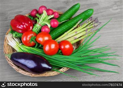 &#xA;Fresh organic vegetables in a basket on wooden vintage table