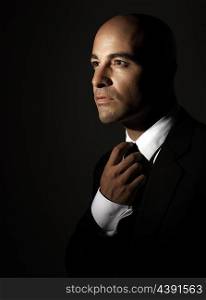 &#xA;Portrait of beautiful handsome man wearing stylish suit isolated on black background, fashion for successful young men