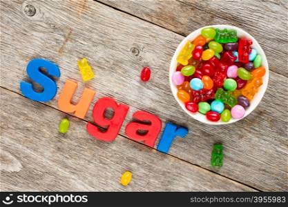 &#xA;Word SUGAR and bowl of mixed candies ,unhealthy food, reduction of eating sweets