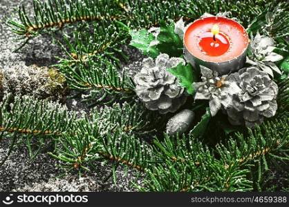 Xmas background with Christmas tree. Spruce branches and Christmas candle on dark background