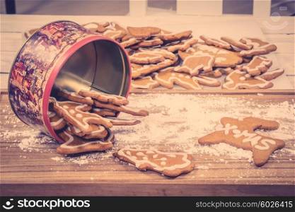 Xmas cookies in a cake tin on a kitchen table