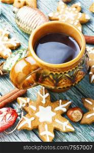 Xmas gingerbread cookies with festive decoration.Christmas cookie on a wooden tabe with tea. Christmas cookieswith tea