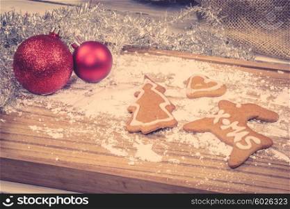 Xmas ornament with homemade cookies on a wooden table