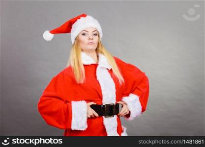 Xmas, seasonal clothing, winter christmas concept. Confident woman wearing Santa Claus helper costume. Confident woman wearing Santa Claus helper costume