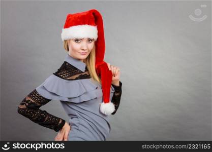 Xmas, seasonal clothing, winter christmas concept. Happy woman wearing Santa Claus helper hat. Happy woman wearing Santa Claus helper hat