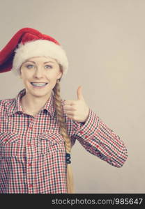 Xmas, seasonal clothing, winter christmas concept. Happy woman wearing windblown Santa Claus helper hat. Happy woman wearing Santa Claus helper hat