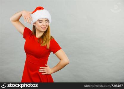 Xmas, seasonal clothing, winter christmas concept. Young smiling positive woman wearing Santa Claus helper costume. Positive woman wearing Santa Claus helper costume