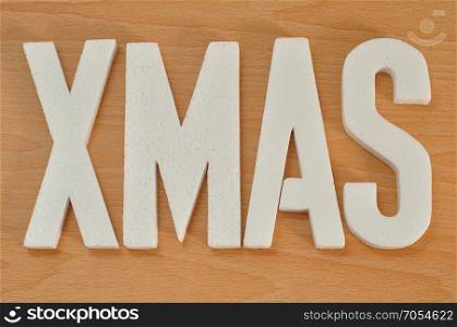Xmas spelled with white polystyrene letters