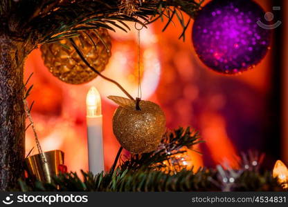 Xmas tree decorated with apples and baubles