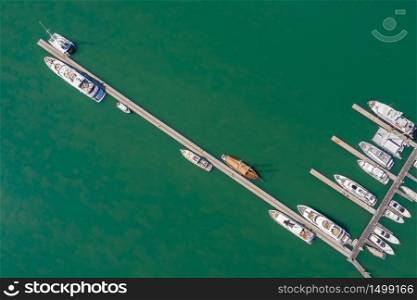 yacht and speedboat parking on the green sea at Phuket Thailand aerial view from drone