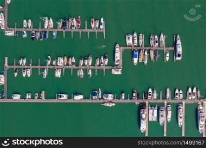 yacht and speedboat parking on the green sea at Phuket Thailand aerial view from drone
