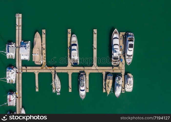 yacht and speedboat parking on the green sea at Phuket Thailand aerial view from drone