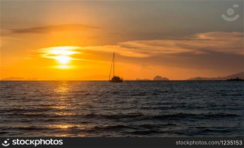 Yacht at anchor at sunset, Kho Phayam, Ranong Province, Thailand