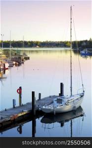 Yacht at the wooden dock in early morning in Tobermory Ontario Canada