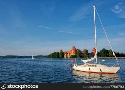 Yacht boats and Trakai Island Castle in lake Galve in day, Lithuania. Trakai Castle is one of major tourist attractions of Lituania. Trakai Island Castle in lake Galve, Lithuania
