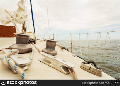 Yacht capstan with rope on sailing boat during cruise, marine objects concept.. Yacht capstan on sailing boat during cruise