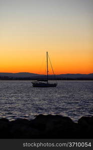 Yacht in the sea at sunset