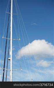 Yacht masts against blue Summer sky