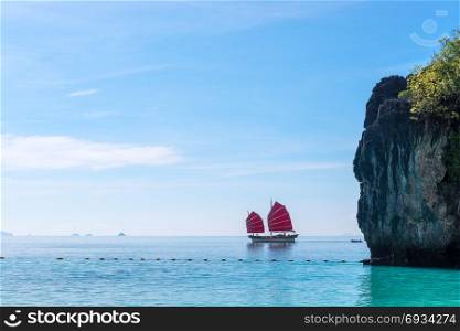 yacht with red sails in the Andaman Sea on a sunny day