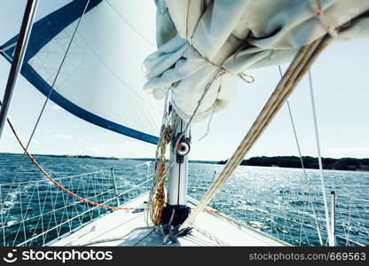 Yachting on sail boat during sunny summer weather on calm blue sea water. Sporty transportation conept.. Yachting on sail boat during sunny weather