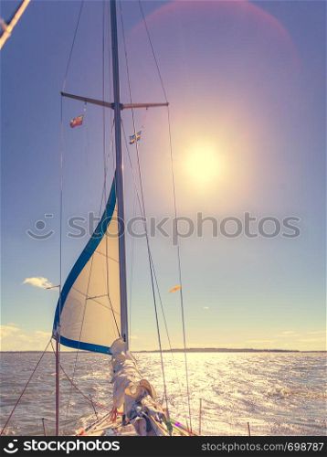 Yachting on sail boat during sunny summer weather on calm blue sea water. Sporty transportation conept.. Yachting on sail boat during sunny weather