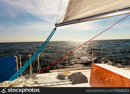 Yachting on sail boat during sunny summer weather on calm blue sea water. Sporty transportation conept.. Yachting on sail boat during sunny weather