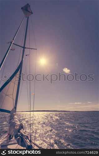 Yachting on sail boat during sunny summer weather on calm blue sea water. Sporty transportation conept.. Yachting on sail boat during sunny weather