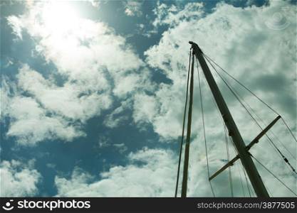 Yachting. Sailboat view of different parts of yacht. Mast against blue summer sky
