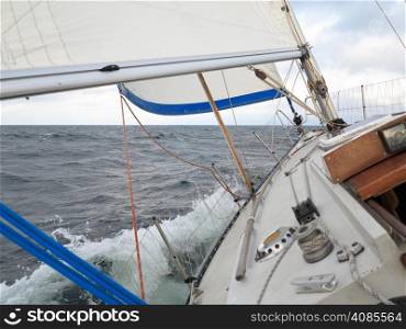 Yachting yacht sailboat sailing in baltic sea overcast sky summer vacation. Tourism luxury lifestyle.