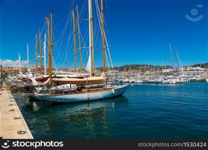 Yachts anchored in port in Cannes in a beautiful summer day, France