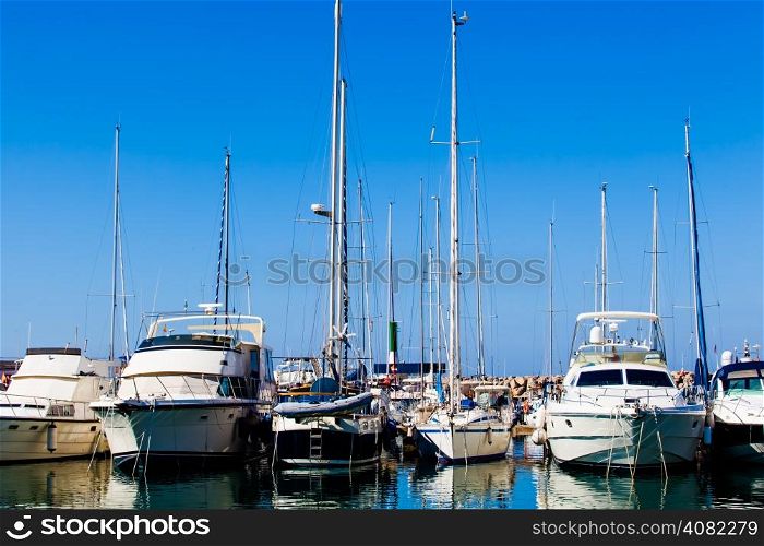 Yachts and boats anchored at a marina. Sailing Boats