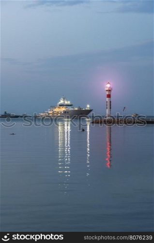 Yachts and lighthouse in Cannes at sunrise