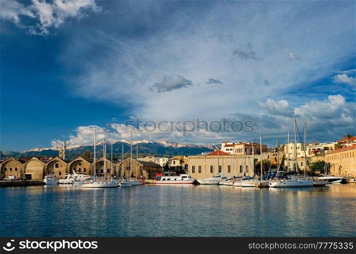 Yachts boats in picturesque old port of Chania is one of landmarks and tourist destinations of Crete island in the morning. Chania, Crete, Greece. Yachts and boats in picturesque old port of Chania, Crete island. Greece