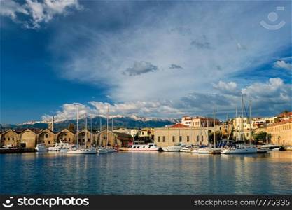 Yachts boats in picturesque old port of Chania is one of landmarks and tourist destinations of Crete island in the morning. Chania, Crete, Greece. Yachts and boats in picturesque old port of Chania, Crete island. Greece