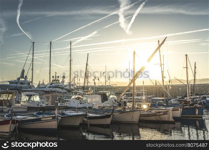 Yachts in Saint-Tropez bay at sunset.